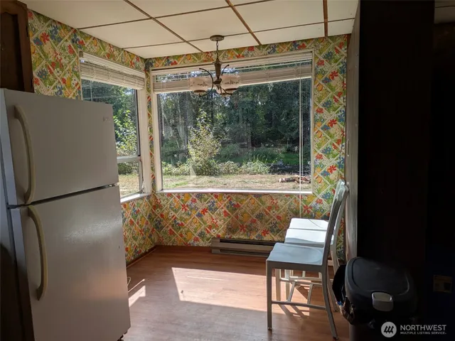 a view of kitchen with furniture and refrigerator