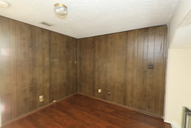 a view of an empty room and wooden floor