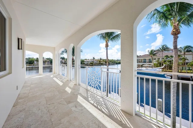 a view of a lake with a big yard and potted plants