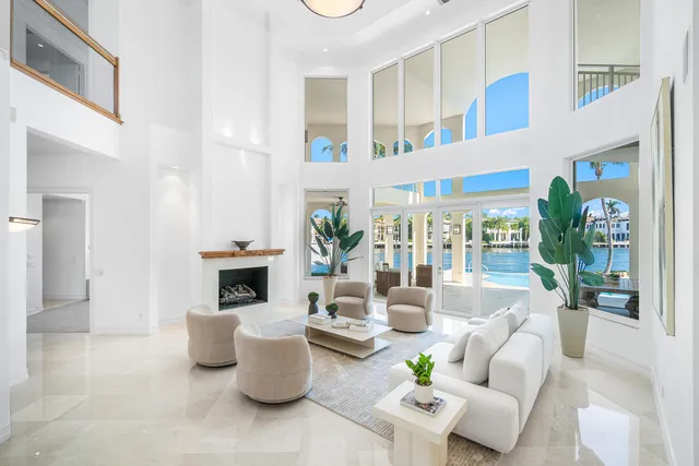 a view of a dining room with furniture one side kitchen view and wooden floor