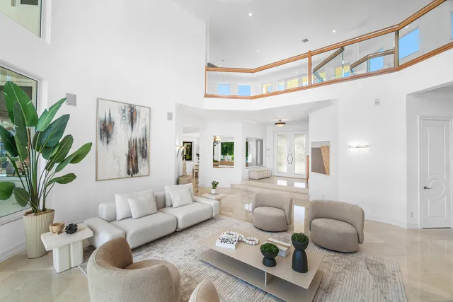 a dining room with furniture a chandelier and a rug
