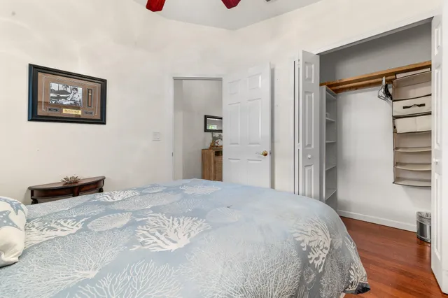 a spacious bedroom with a bed and a chandelier