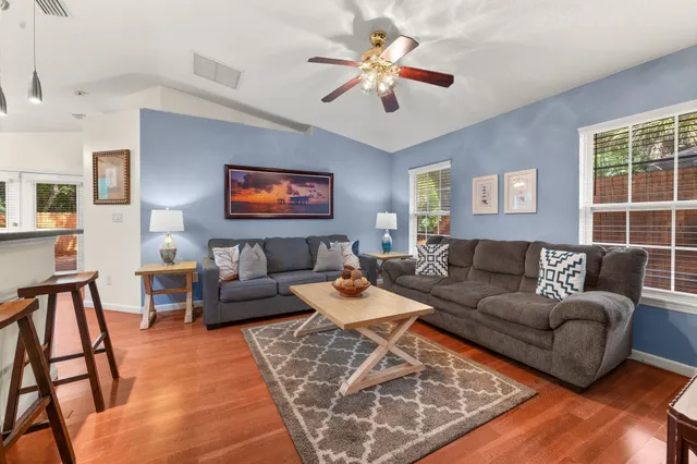 a living room with furniture ceiling fan and a rug