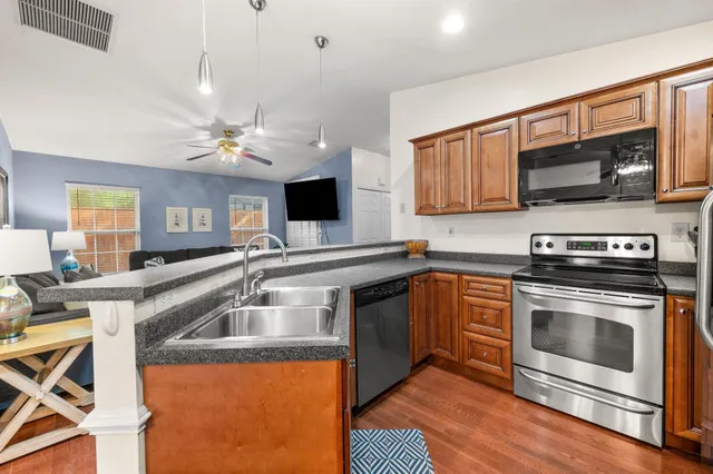 a front view of a house with a garden and trees