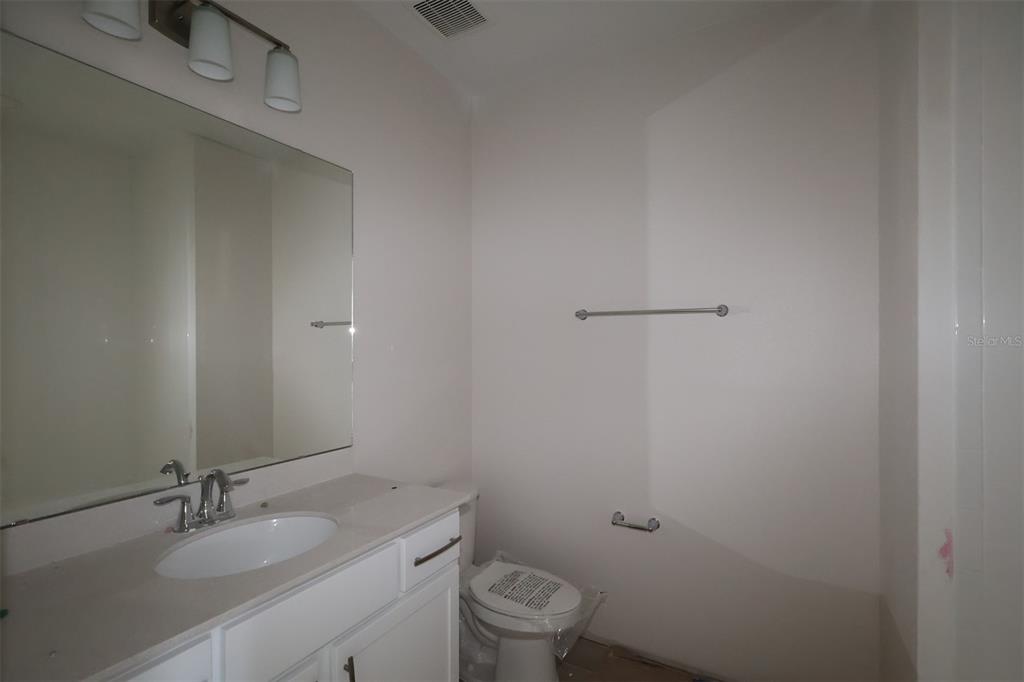5204 Ctr Lk Rnch Boulevard St. Cloud, FL 34771 - Photo 12 of 24 a bathroom with a granite countertop toilet a sink and mirror