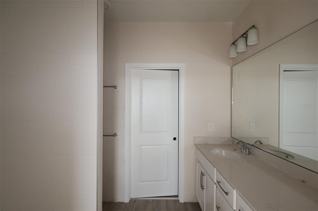 5204 Ctr Lk Rnch Boulevard St. Cloud, FL 34771 - Photo 13 of 24 a bathroom with a granite countertop sink and a mirror