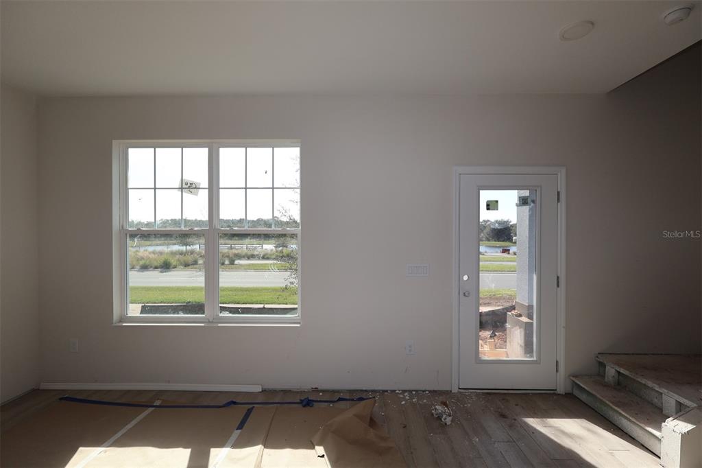 5204 Ctr Lk Rnch Boulevard St. Cloud, FL 34771 - Photo 16 of 24 an empty room with wooden floor and windows