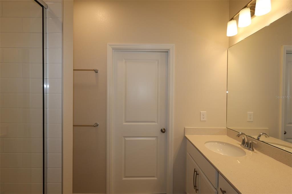 5204 Ctr Lk Rnch Boulevard St. Cloud, FL 34771 - Photo 16 of 24 a bathroom with a granite countertop sink and a mirror