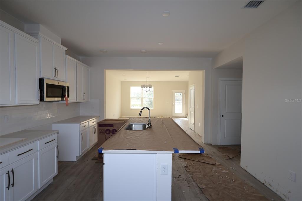5204 Ctr Lk Rnch Boulevard St. Cloud, FL 34771 - Photo 4 of 24 a kitchen with a stove a sink and a microwave