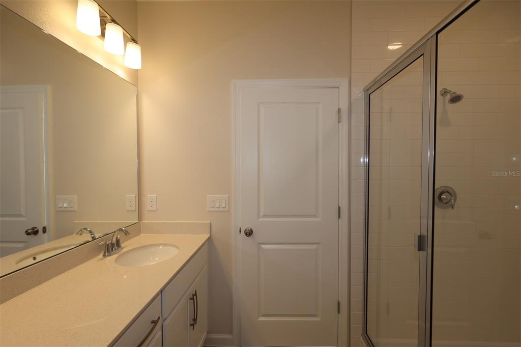5204 Ctr Lk Rnch Boulevard St. Cloud, FL 34771 - Photo 5 of 24 a bathroom with a double vanity sink and mirror