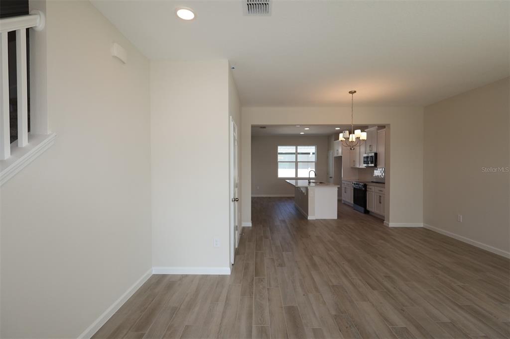 5204 Ctr Lk Rnch Boulevard St. Cloud, FL 34771 - Photo 6 of 24 an empty room with wooden floor and windows