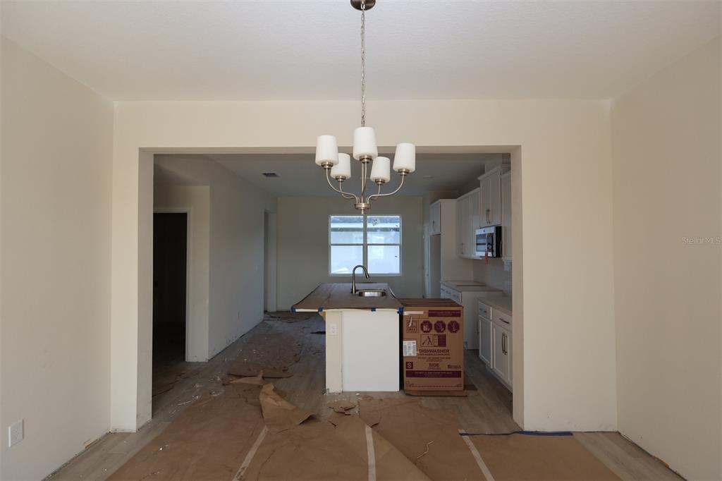 5204 Ctr Lk Rnch Boulevard St. Cloud, FL 34771 - Photo 7 of 24 a room with chandelier and window