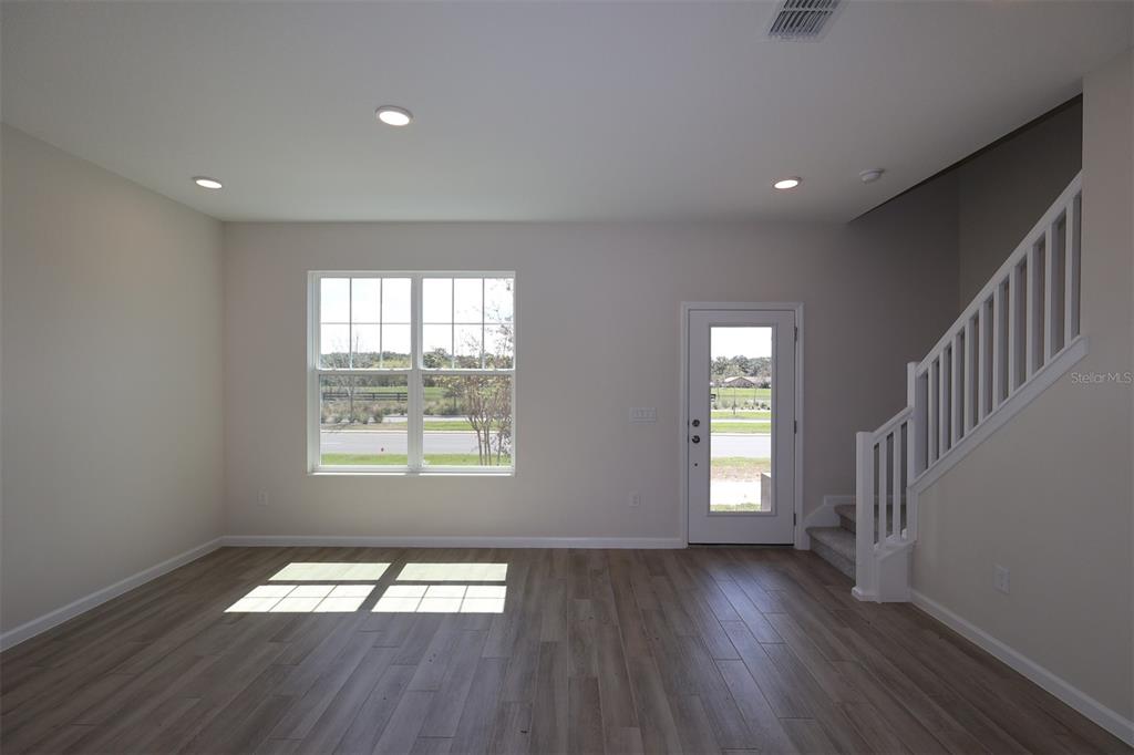 5204 Ctr Lk Rnch Boulevard St. Cloud, FL 34771 - Photo 10 of 24 an empty room with wooden floor and windows