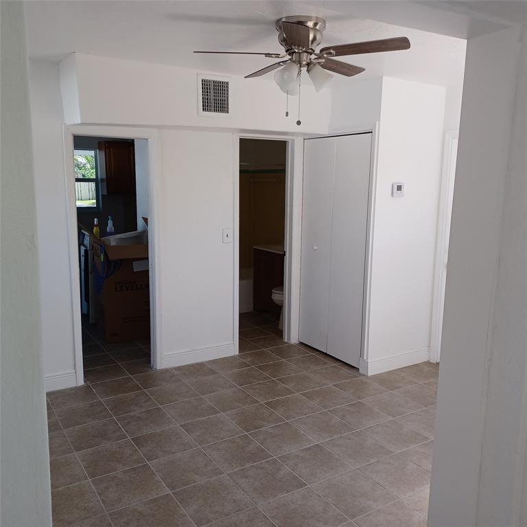 618 58th Street, Unit A West Palm Beach, FL 33407 - Photo 3 of 6 an empty room with closet and a chandelier fan