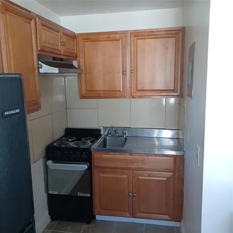 a kitchen with appliances cabinets and a sink