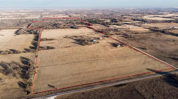 a front view of a house with a yard covered with snow