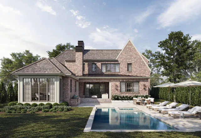 a front view of a house with swimming pool and furniture