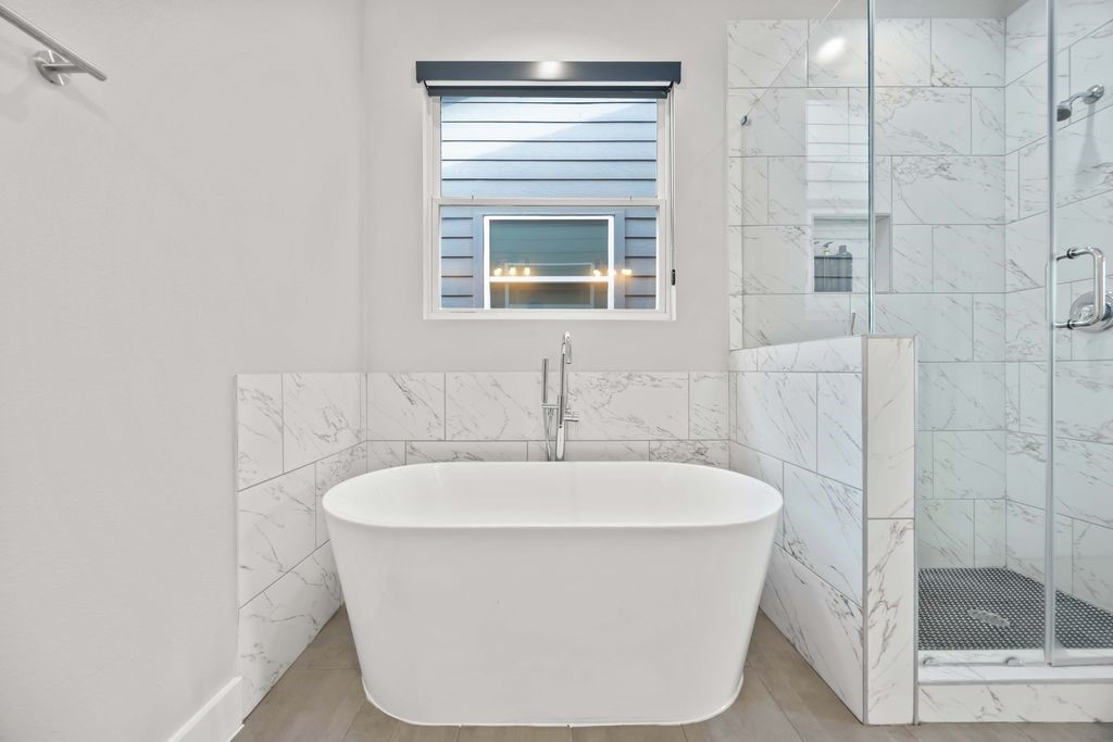 705 Gregg Street Houston, TX 77020 - Photo 22 of 27 a white bath tub sitting in a bathroom