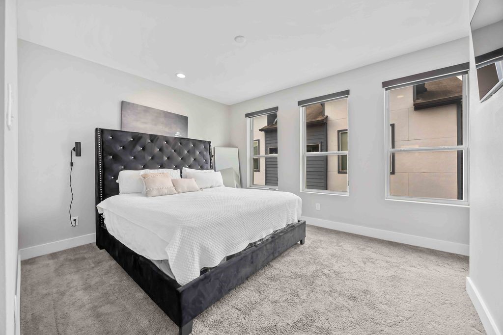 705 Gregg Street Houston, TX 77020 - Photo 5 of 27 a large bed sitting in a bedroom next to a window and a larger closet