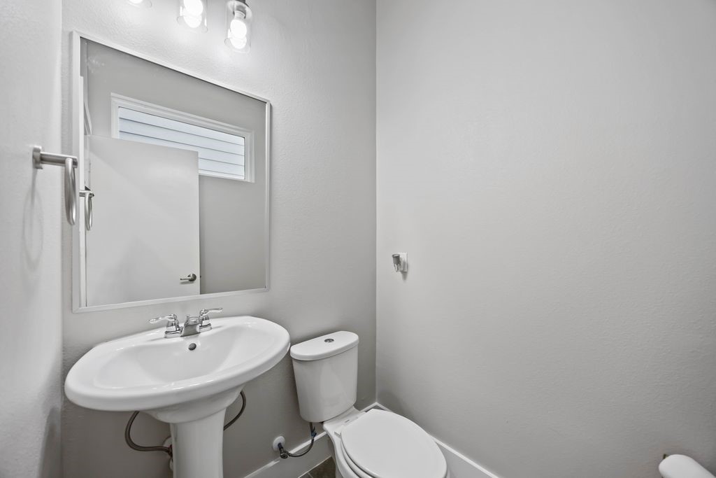 705 Gregg Street Houston, TX 77020 - Photo 6 of 27 a bathroom with a sink a toilet and mirror