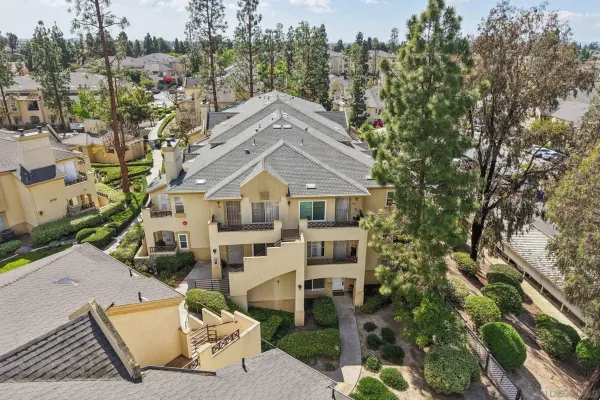 an aerial view of a house with a yard