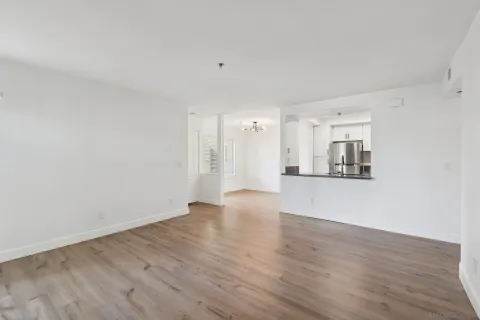 a view of a room with a window and wooden floor