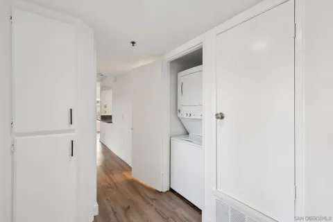 an empty room with wooden floor and closet area