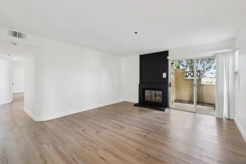 a view of an empty room with fire place and a fireplace