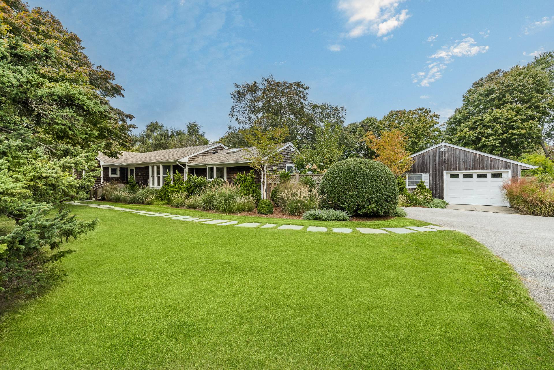14 Sunset Road Sag Harbor, NY 11963 - Photo 1 of 19 a front view of a house with a yard