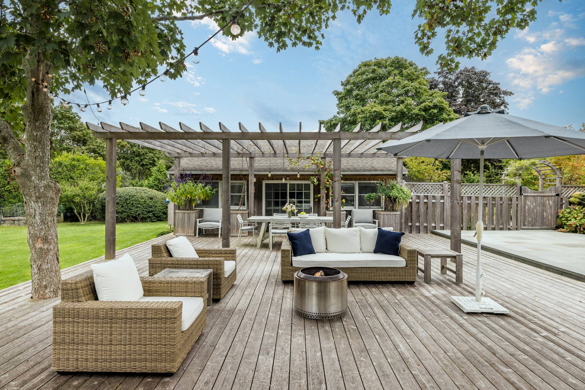 14 Sunset Road Sag Harbor, NY 11963 - Photo 14 of 19 a view of a patio with couches potted plants and a patio