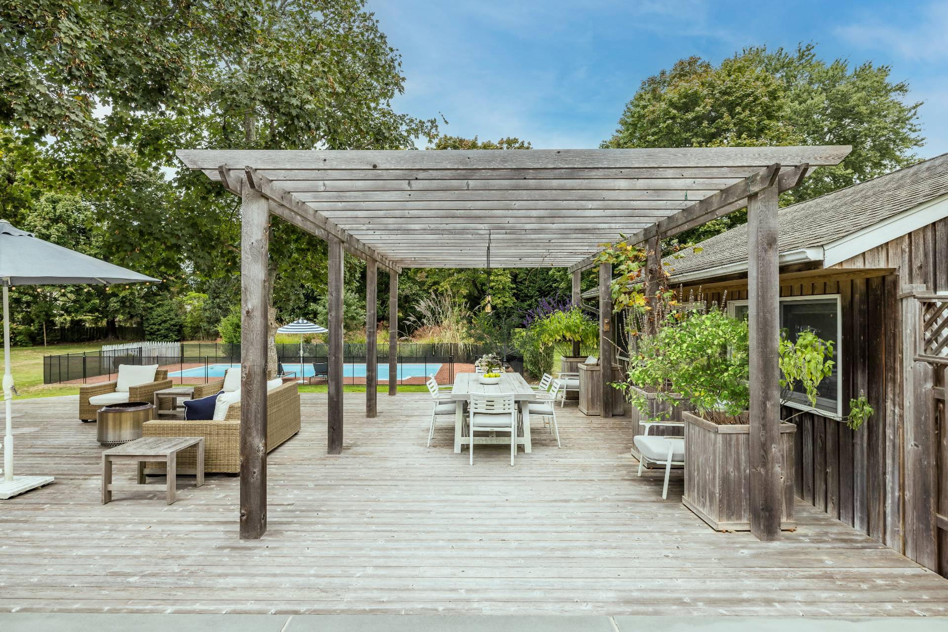 14 Sunset Road Sag Harbor, NY 11963 - Photo 15 of 19 a patio with glass top table and chairs