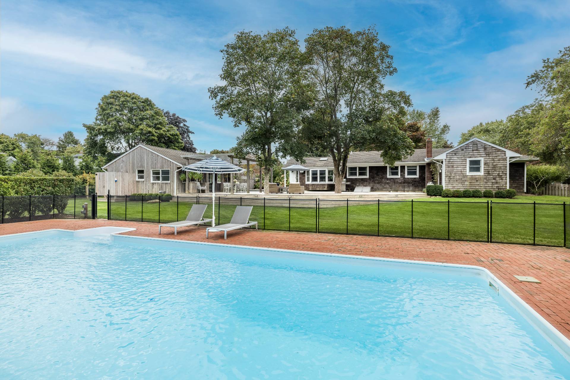 14 Sunset Road Sag Harbor, NY 11963 - Photo 17 of 19 a view of a house with a big yard and potted plants