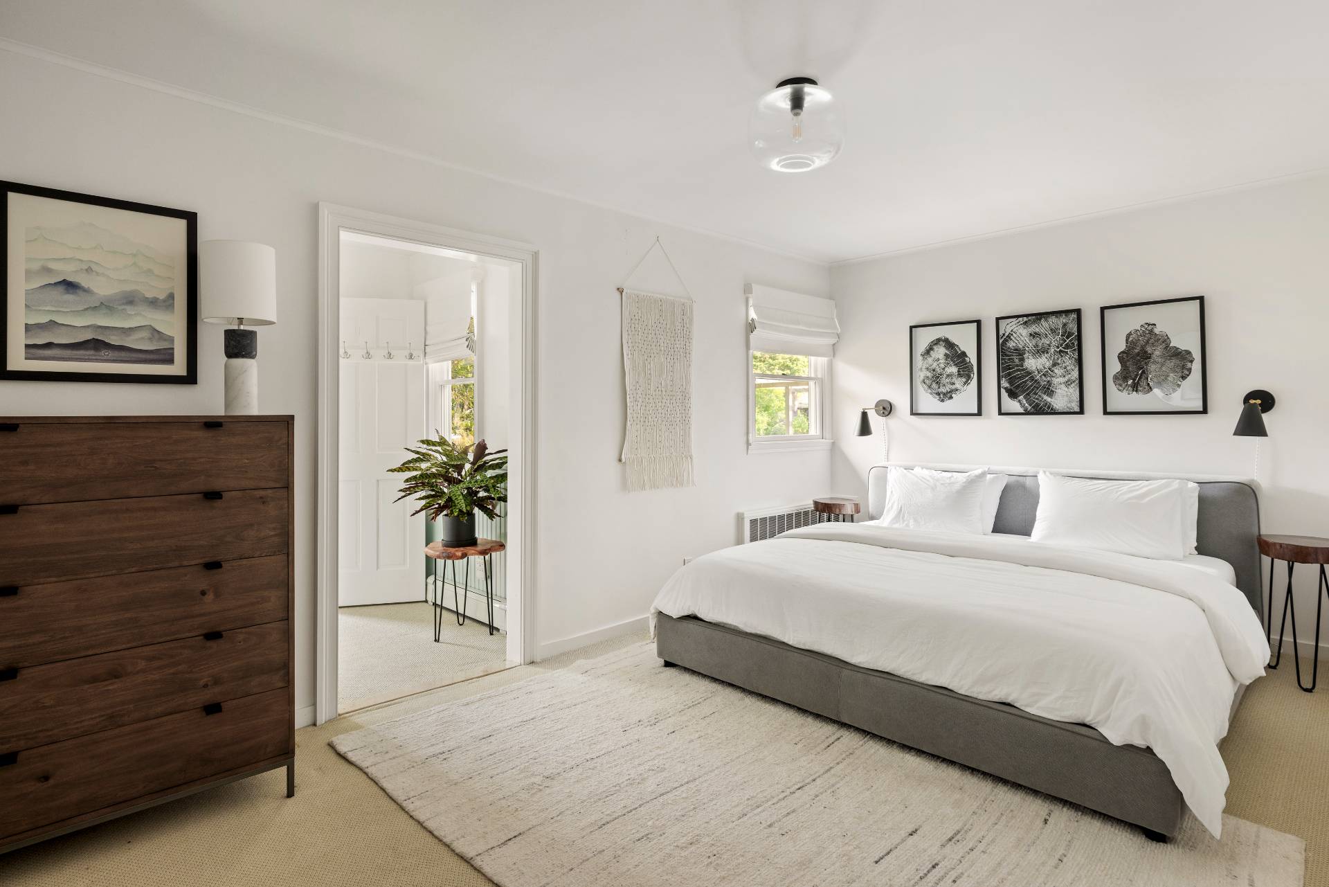 14 Sunset Road Sag Harbor, NY 11963 - Photo 7 of 19 a bedroom with a large bed and a potted plant