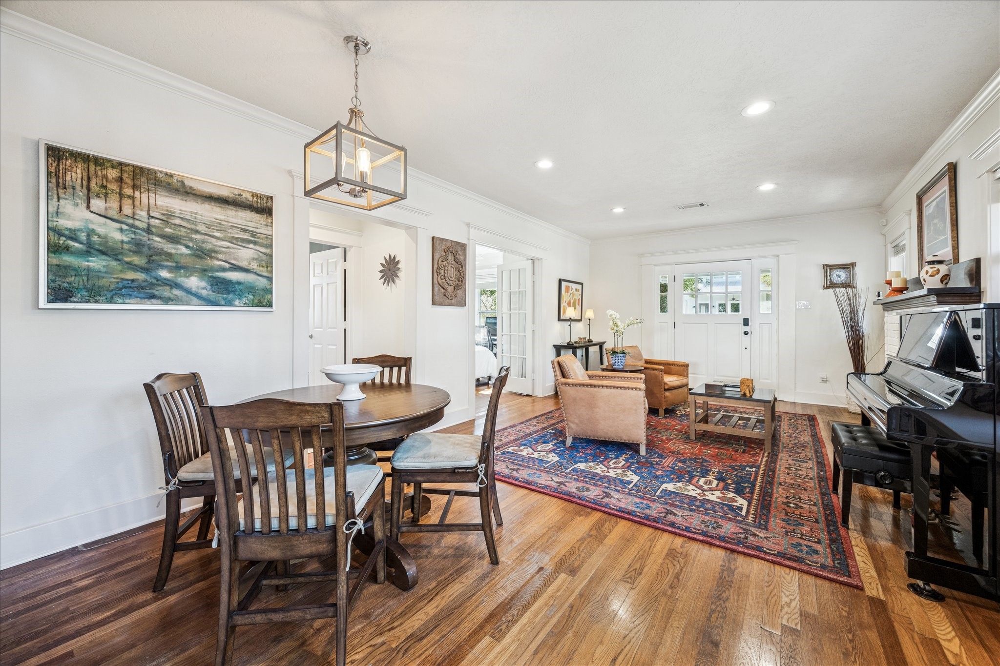 825 Merrill Street Houston, TX 77009 - Photo 16 of 37 The dining area is anchored by a stylish chandelier and enjoys excellent natural light from the wall of windows opposite it.