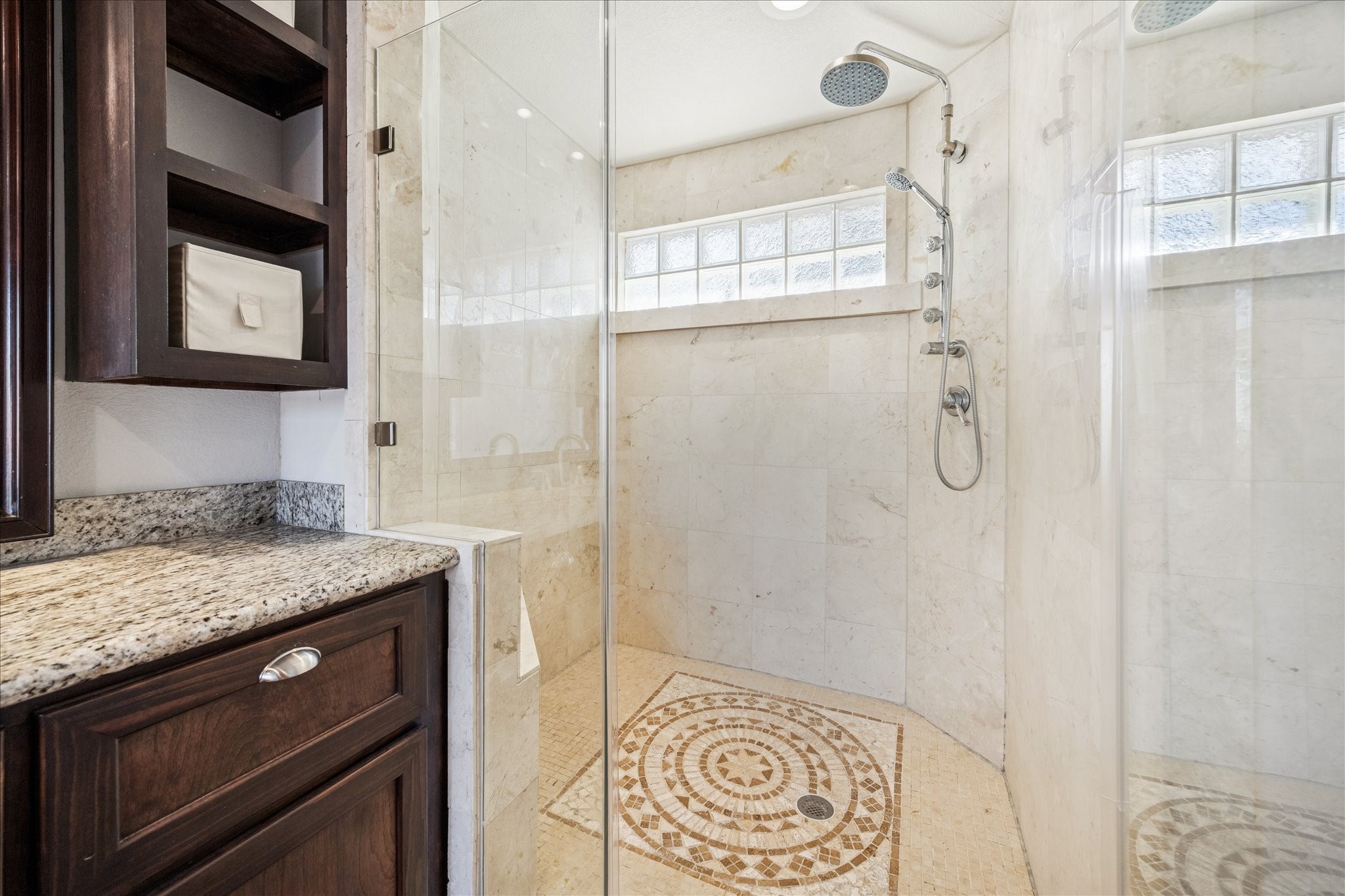 825 Merrill Street Houston, TX 77009 - Photo 23 of 37 The spacious glass enclosed shower features marble walls, intricate tile flooring and multiple shower heads.