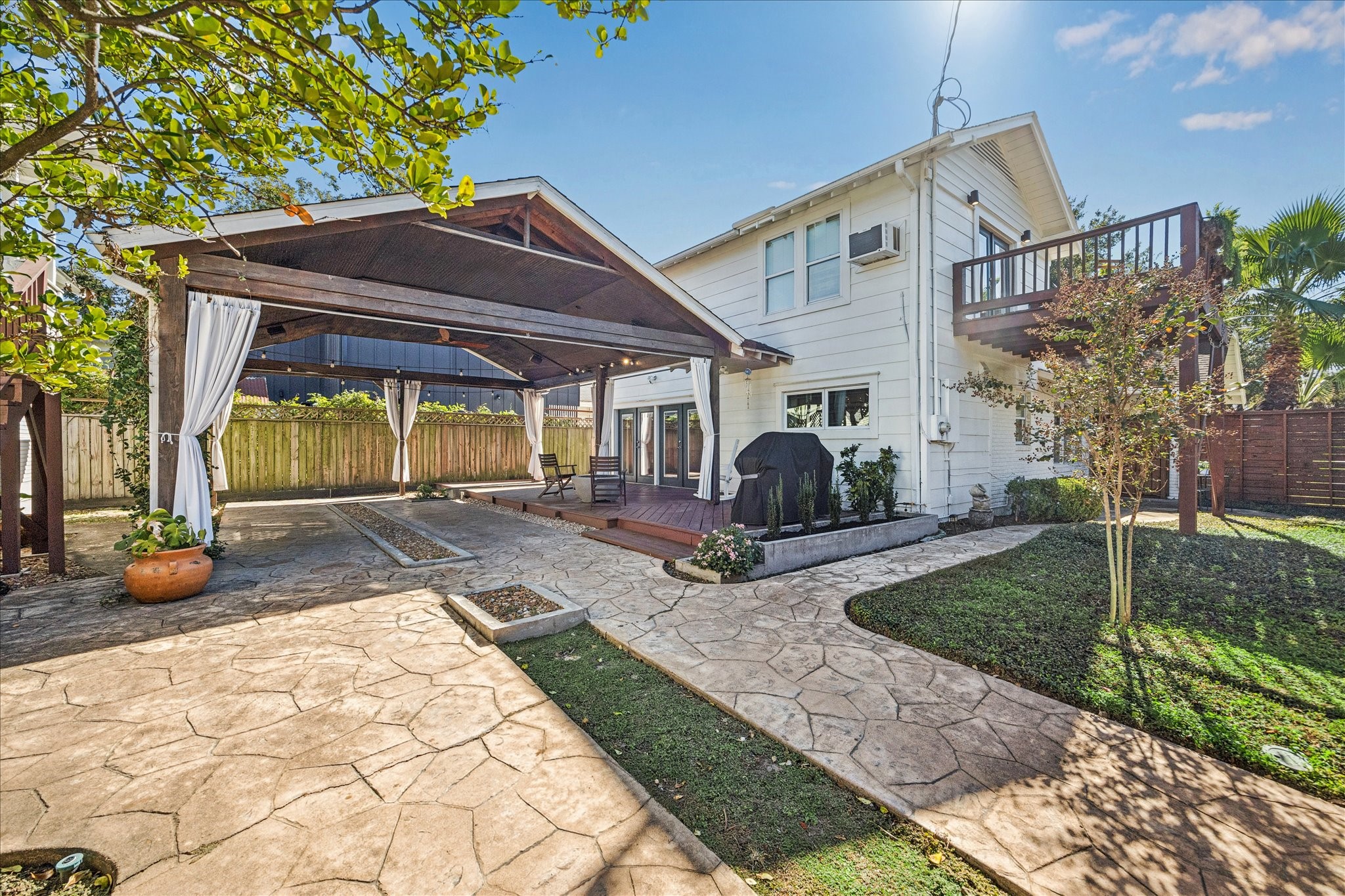 825 Merrill Street Houston, TX 77009 - Photo 32 of 37 The expansive, landscaped yard offers plenty of space for entertaining and room for loved ones to run and play.