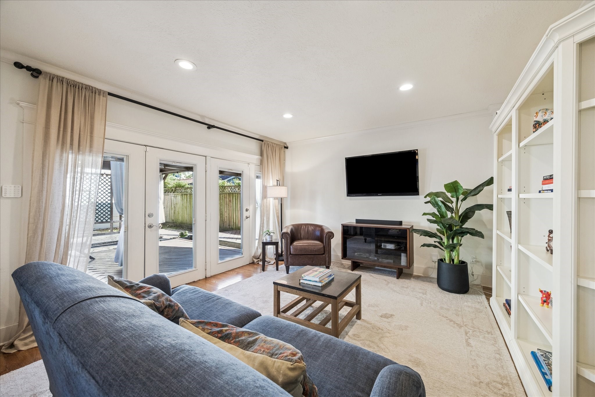 825 Merrill Street Houston, TX 77009 - Photo 9 of 37 Spacious living room with built-ins to showcase your favorite items and French doors leading to the back patio.