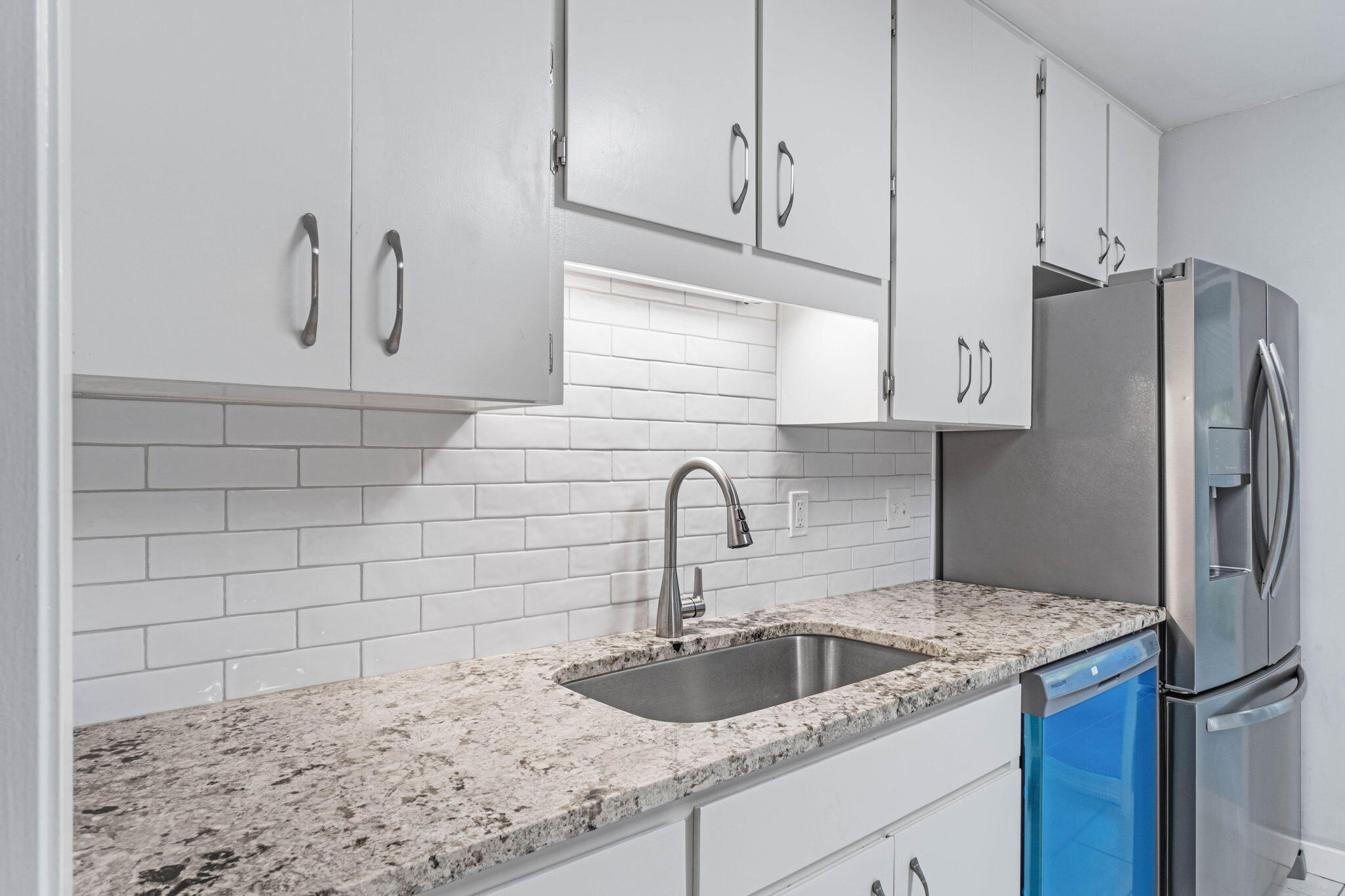 14 9th Street Shalimar, FL 32579 - Photo 11 of 29 a kitchen with stainless steel appliances granite countertop a sink and a refrigerator