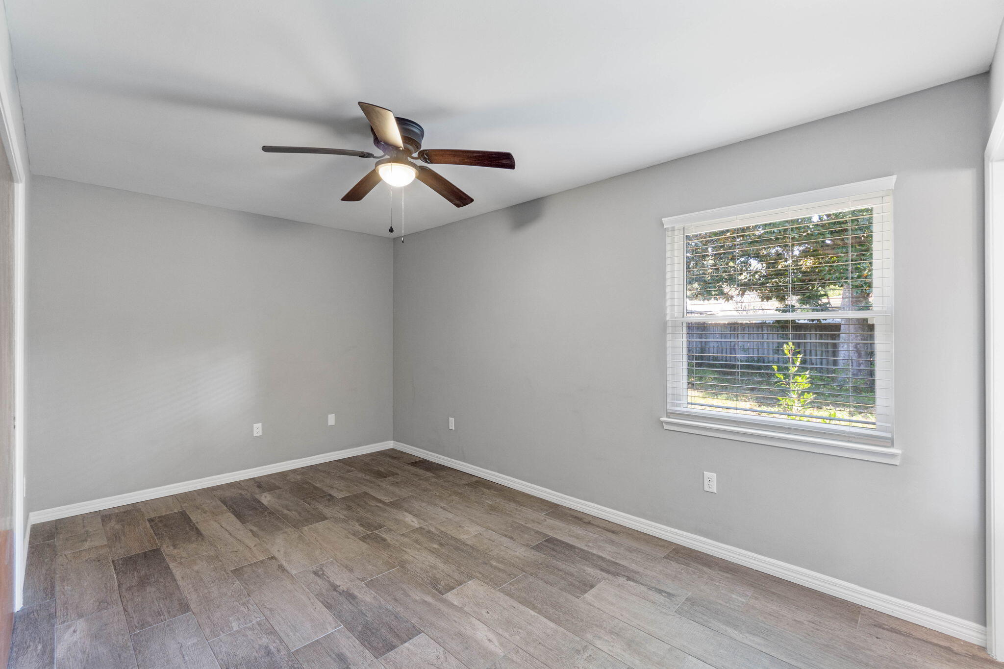 14 9th Street Shalimar, FL 32579 - Photo 23 of 29 a view of empty room with wooden floor and fan