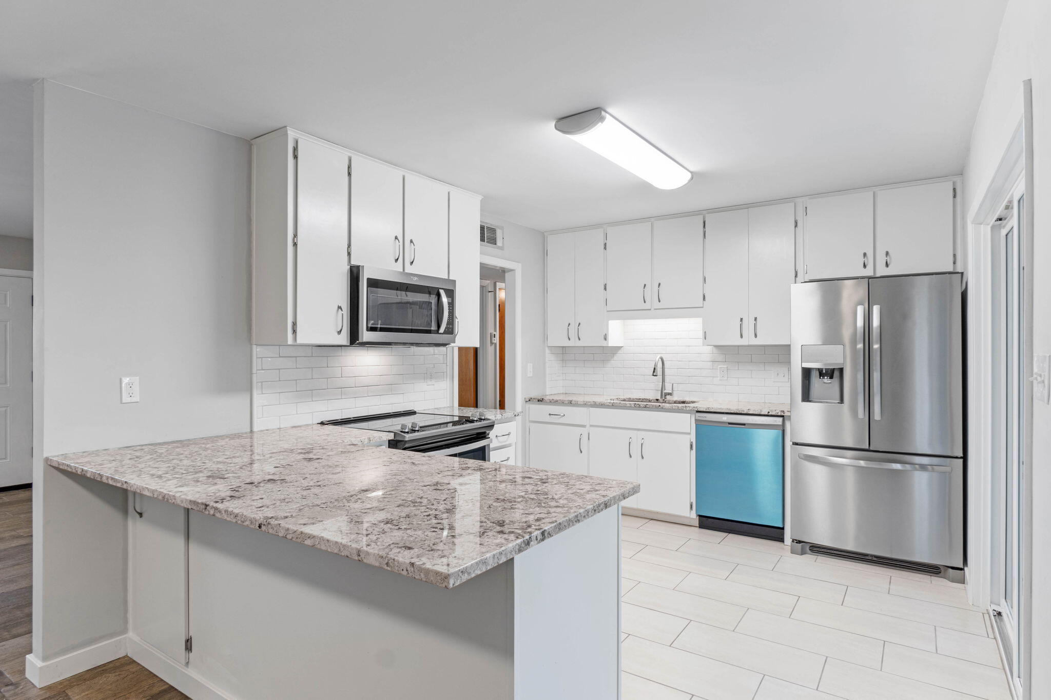 14 9th Street Shalimar, FL 32579 - Photo 9 of 29 a kitchen with granite countertop a sink stove and refrigerator