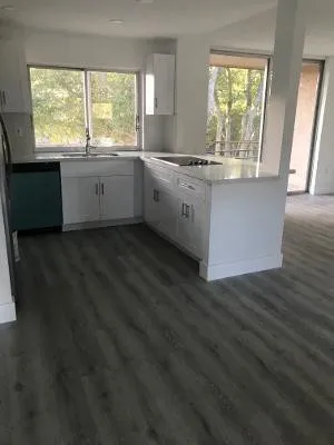 a view of a kitchen counter space and wooden floor