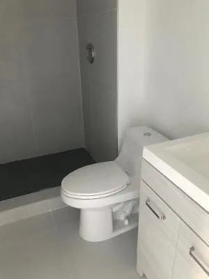 a white toilet sitting next to a white sink
