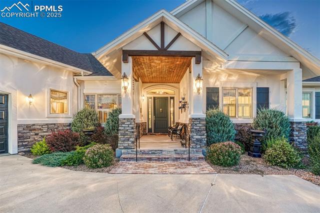 1935 Bashley Road Monument, CO 80132 - Photo 11 of 45 The covered entry, welcoming and tastefully lit, sets the tone as you enter this gracious home
