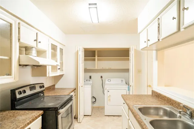 a kitchen with a stove a refrigerator and a sink