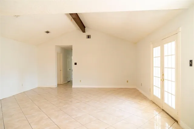 a view of a small space with wooden floor and a chandelier fan