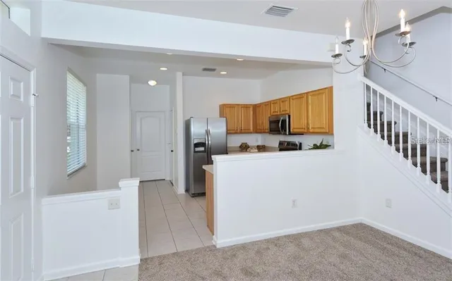 a view of kitchen with furniture and a refrigerator