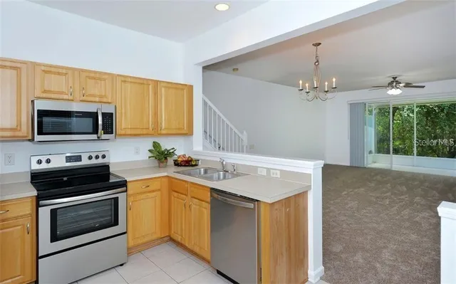 a kitchen with a sink stove and microwave