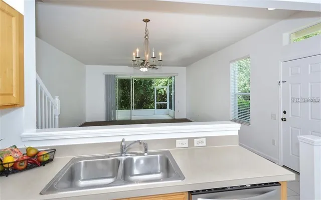 a view of a sink and dishwasher with wooden floor