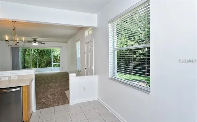 a room with a window and a kitchen