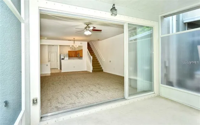 an empty room with wooden floor and garden